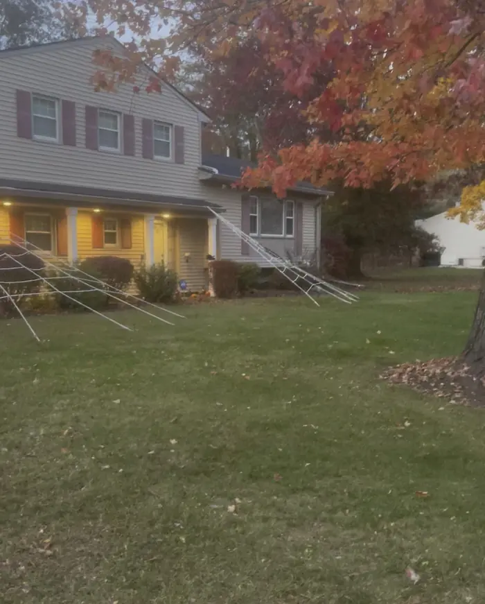 A cleared front lawn in front of a two-story house at dusk